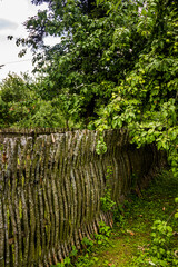 vintage wooden wicker fence in reconstruction of ukrainian village of 19th century