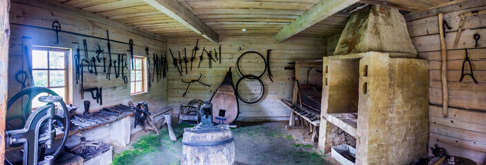 interior of vintage blacksmith workshop in reconstruction of ukrainian village of 19th century