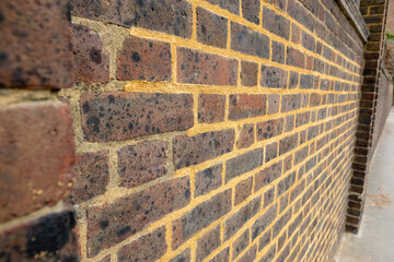 Repointing work on an old brick wall with mortar mix 