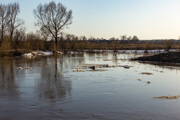 Ice drift on the river. Ice floes floating on the water. Spring sunny day.