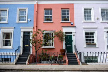 Colourful street of upmarket townhouses in Notting Hill area of West London