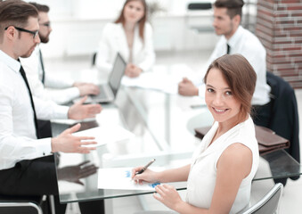 smiling young business woman at workplace in office