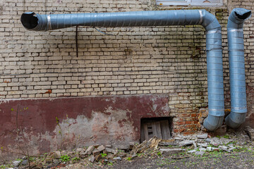 old duct pipe sticking out of a brick wall - obrazy, fototapety, plakaty