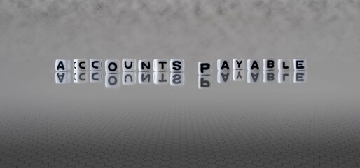 accounts payable word or concept represented by black and white letter cubes on a grey horizon background stretching to infinity