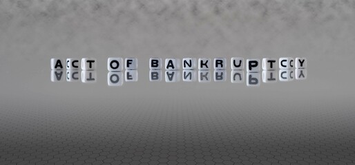 act of bankruptcy word or concept represented by black and white letter cubes on a grey horizon...