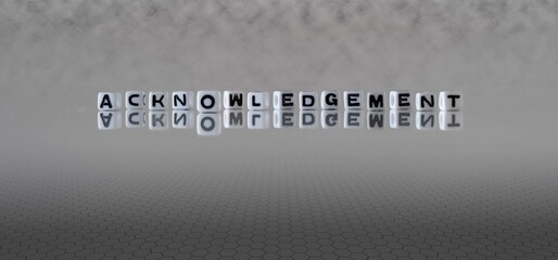 acknowledgement word or concept represented by black and white letter cubes on a grey horizon...