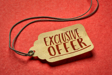 exclusive offer -  sign a paper price tag against textured red paper, shopping and marketing concept