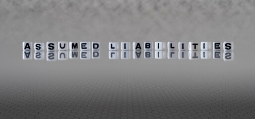 assumed liabilities word or concept represented by black and white letter cubes on a grey horizon...