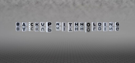 backup withholding word or concept represented by black and white letter cubes on a grey horizon...