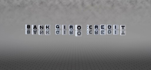 bank giro credit word or concept represented by black and white letter cubes on a grey horizon...