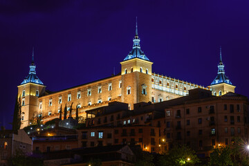 The Alcazar de Toledo illuminated by night. Historical landmark in Spain