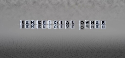beneficial owner word or concept represented by black and white letter cubes on a grey horizon...
