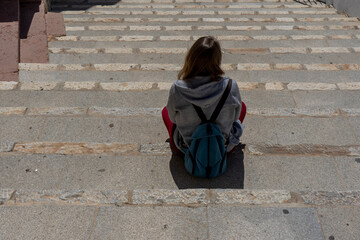 WOMAN SITTING ON THE STAIRS THINKING