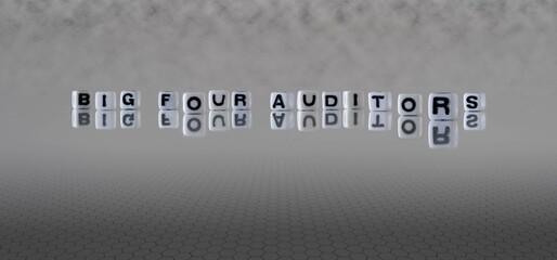 big four auditors word or concept represented by black and white letter cubes on a grey horizon background stretching to infinity