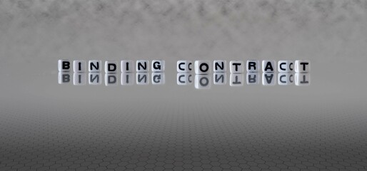 binding contract word or concept represented by black and white letter cubes on a grey horizon...