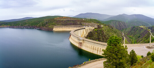 Fototapeta na wymiar Panoramic reservoir between the green mountains with swamp dam containing the water, Atazar, Madrid.