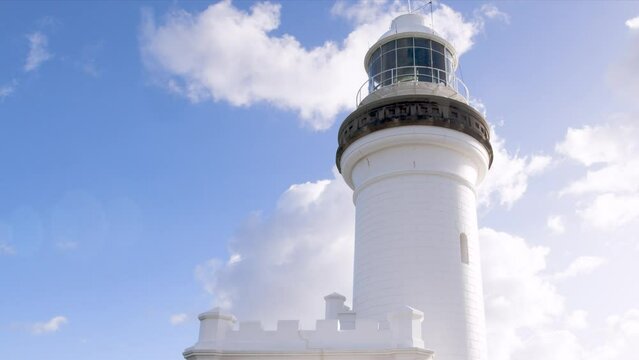 The beacon lamp of the Cape Byron lighthouse reflects the sunshine as it rotates on a beautiful 
sunny day.