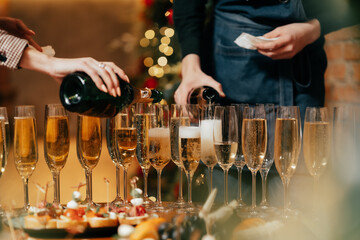 in the restaurant on the table there are glasses in which champagne is poured with warm lighting