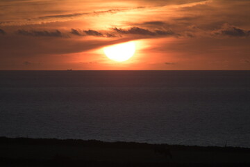 orange sunset on beach with clouds