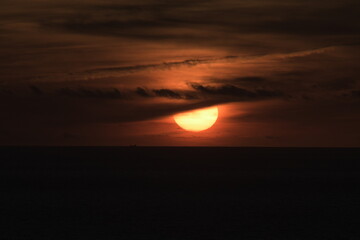 orange sunset on beach with clouds