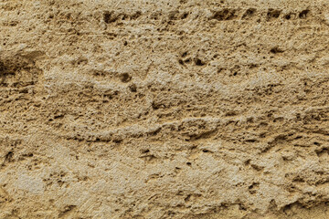 Beige yellow sandstone background, ancient rough sand rock textured surface