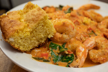 Cornbread Served with Shrimp and Polenta in a Tomato Based Sauce