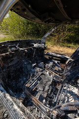 Newburn UK: 29th April 2022: A stolen car which has been burnt out and dumped in a field