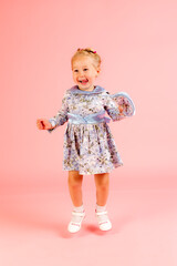 cheerful girl on a pink background