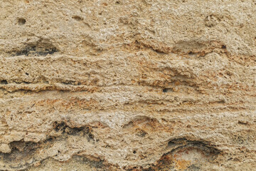 Beige yellow sandstone background, ancient rough sand rock textured surface