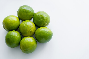 Top view of round limes on white background