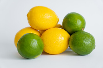 Fresh limes and limes on white surface