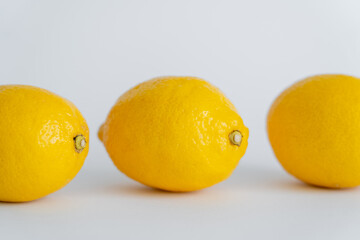 Close up view of juicy lemons on white surface
