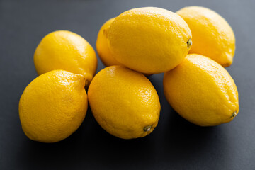 Close up view of juicy lemons on black background