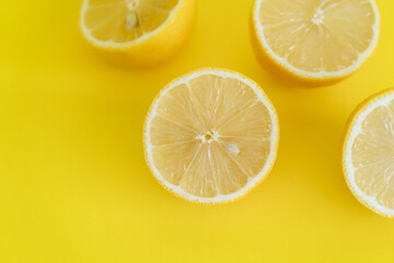 Fototapeta na wymiar Top view of halves of lemons on yellow background