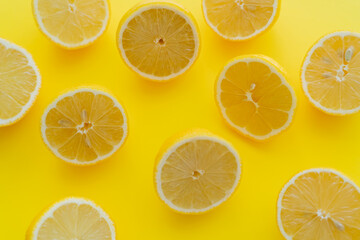 Top view of halves of fresh lemons on yellow surface