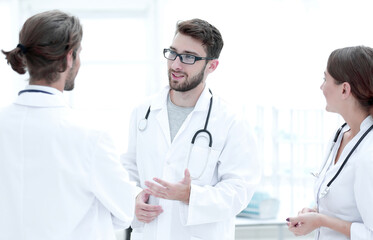 Fototapeta na wymiar Medical staff discuss in a modern hospital room