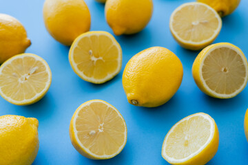 Close up view of juicy lemons on blue background