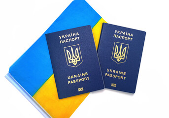 Ukrainian passport lies on the flag of Ukraine isolated on a white background