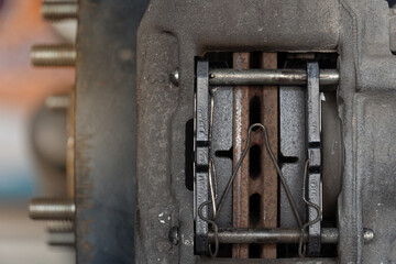 Close-up view of the inside of a caliper with new of breaker pads. car maintenance background.
