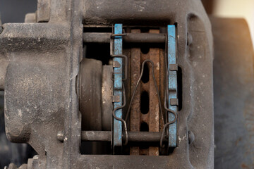 Close-up view of the inside of a caliper with used of breaker pads. car maintenance background.