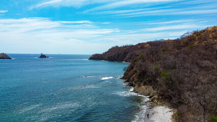 Fototapeta na wymiar Aerial view of the beach in Costa Rica, Central America. Costa Rica has fantastic beaches and stunning landscapes with lots of nature. The country is famous for ecotourism. 