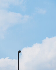 street lamp against blue sky