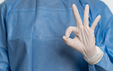 People in protective suit and medical mask on white background showing ok gesture