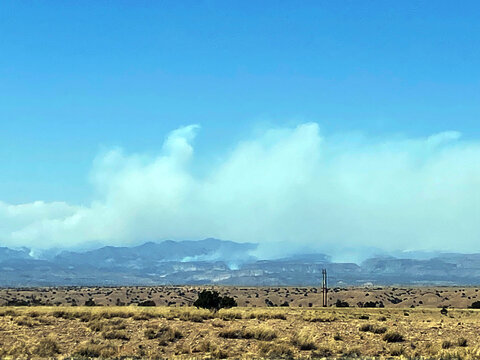 Smoke billows from wildfires in the Jemez Mountains of New Mexico, photographed from I-25 on May 3, 2022