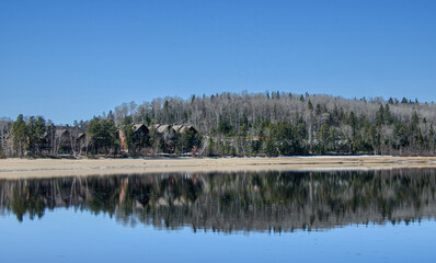 Fototapeta premium In spring, beautiful lake in the Canadian forest in the province of Quebec