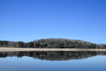 Fototapeta premium In spring, beautiful lake in the Canadian forest in the province of Quebec
