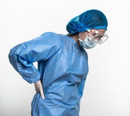 Female doctor or nurse wearing protective suit is suffering from lumbago