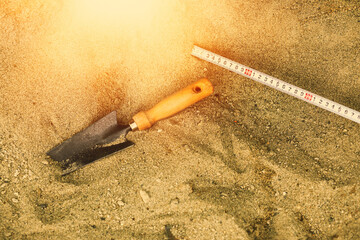 Shovel in the sand.Skeleton and archaeological tools.Digging for fossils.