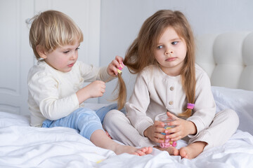 cute kid boy braids pigtails using colorful elastic bands for hair for little girl sister