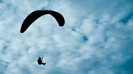 Silhouette of a skydiver in the sky
